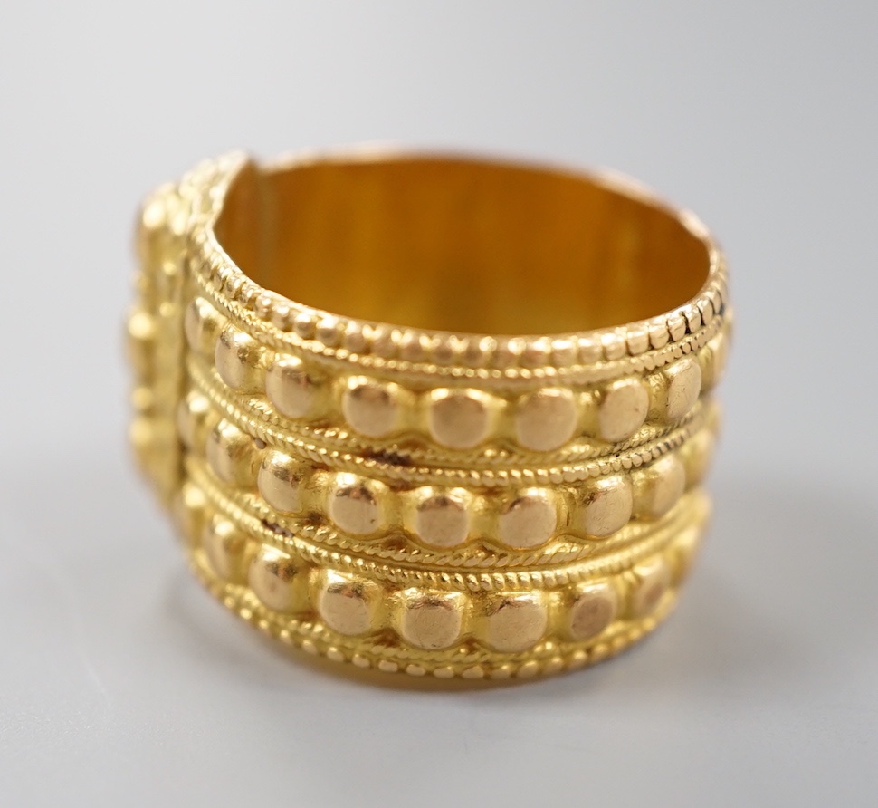 A Middle Eastern embossed yellow metal ring, size O/P, 14.8 grams.